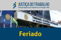 Fachada do prédio-sede do TRT16 com bandeiras hasteadas do Brasil, do Maranhão e do Tribunal. Abaixo, texto Feriado na cor amarela sobre faixa azul. 