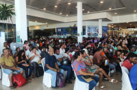 Foto mostra várias pessoas sentadas no aguardo de serem atendidas pelos serviços da Ação Praça de Justiça e Cidadania