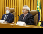 Foto do  presidente do TST e CSJT, ministro Emmanoel Pereira, ao lado do presidente do Coleprecor e do TRT da 17ª Região (ES), desembargador Marcello Maciel Mancilha, durante abertura da 2ª reunião ordinária do Colégio de Presidentes e Corregedores de Tribunais Regionais do Trabalho. Ambos estão sentados, estão trajando ternos escuros. Na bancada há microfones e placas com seus nomes, ao fundo a bandeira do Brasil e persianas na cor amarela