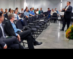 Imagem perpendicular do desembargador que veste terno escuro e fala para a plateia de magistradas e magistrados sentados no auditório da Escola Judicial