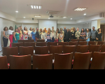 grupo de pessoas posam para a foto em auditório